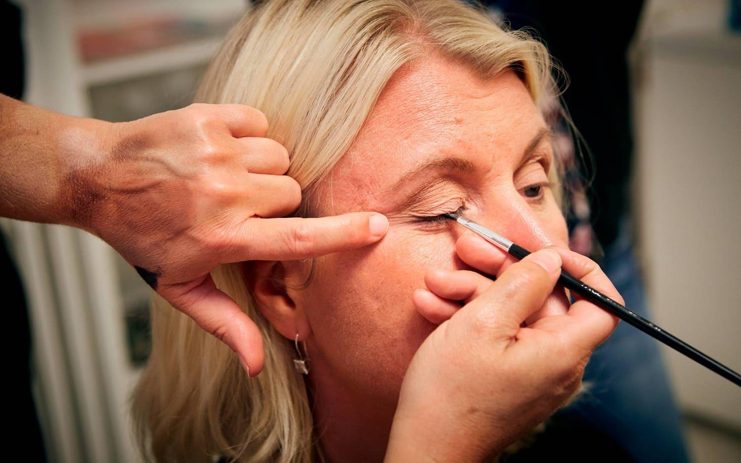 Monica Thompson får instruktioner om eyeliner.