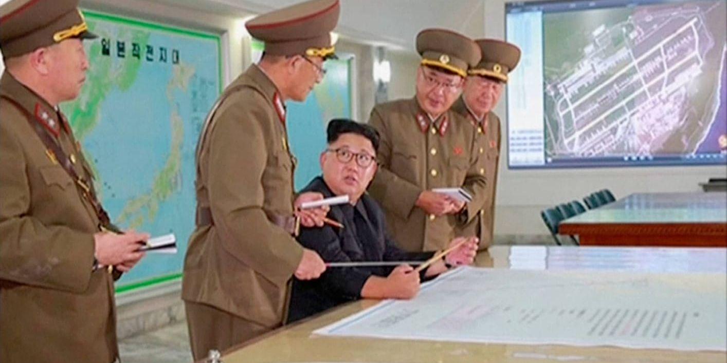 Nordkoreas ledare Kim Jong-Un informeras om detaljer i planerna på provskjutningar av robotar mot mål nära den amerikanska ön Guam. Bild från den 14 augusti. Inga oberoende massmedier fick vara på plats vid tillfället.