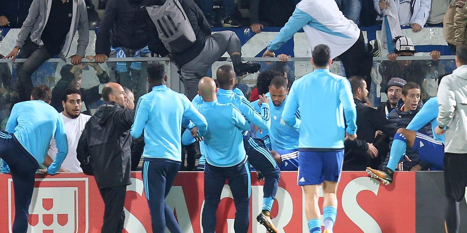 Lagkamraterna i Marseille fick dra undan Patrice Evra från supportrar under uppvärmningen inför Europa League-matchen mot Guimarães den 2 november.