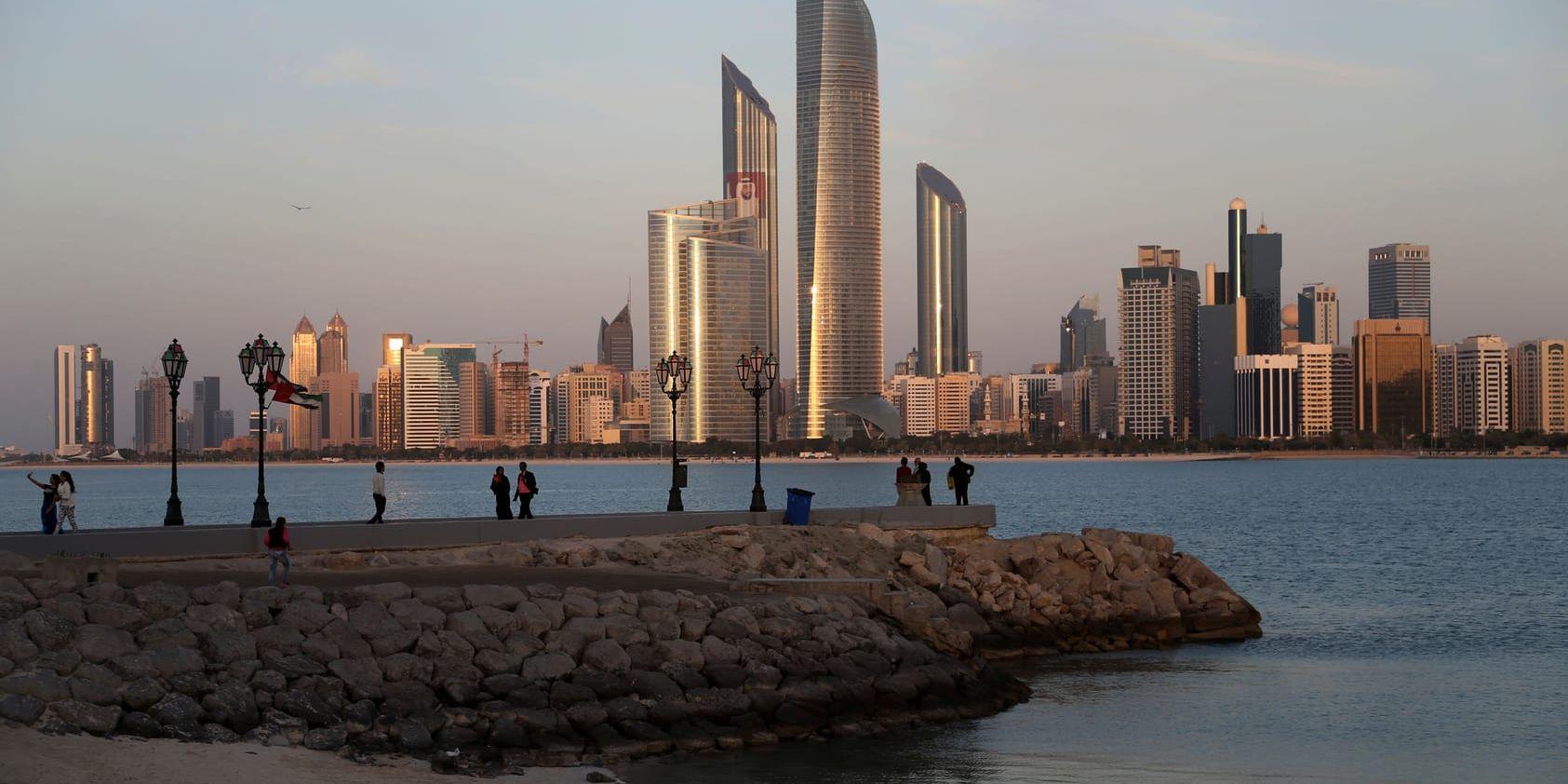 With the city skyline in backdrop, people of different nationalities enjoy a good weather of 24 degrees Celsius (75.2 degrees Fahrenheit) a day before the HSBC Golf Championship in Abu Dhabi, United Arab Emirates, Wednesday, Jan. 14, 2015.
