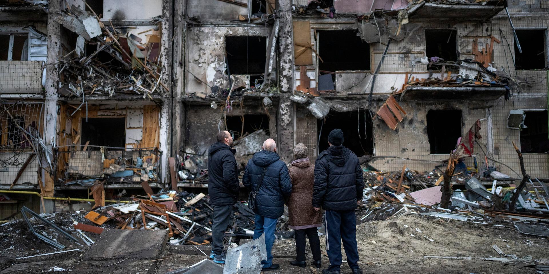 People look at the damage following a rocket attack the city of Kyiv, Ukraine, Friday, Feb. 25, 2022. (AP Photo/Emilio Morenatti)  EM106