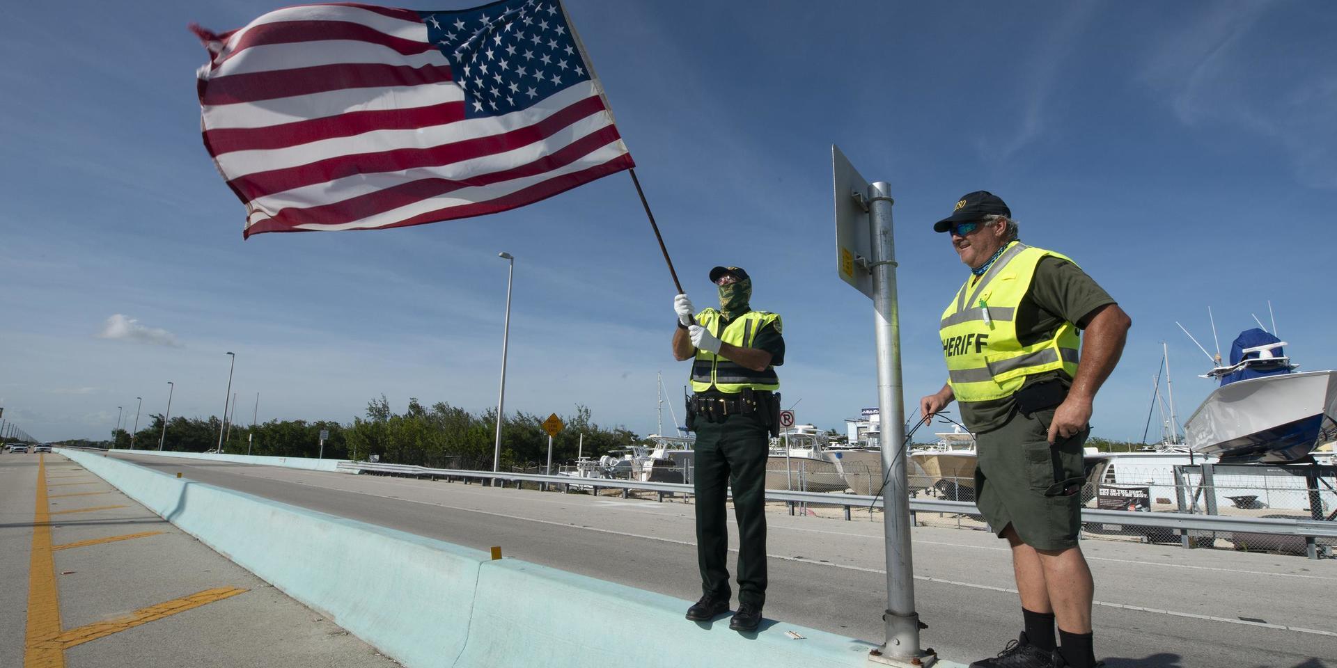 Två poliser med den amerikanska flaggan vid Key Largo i Florida. Arkivbild.