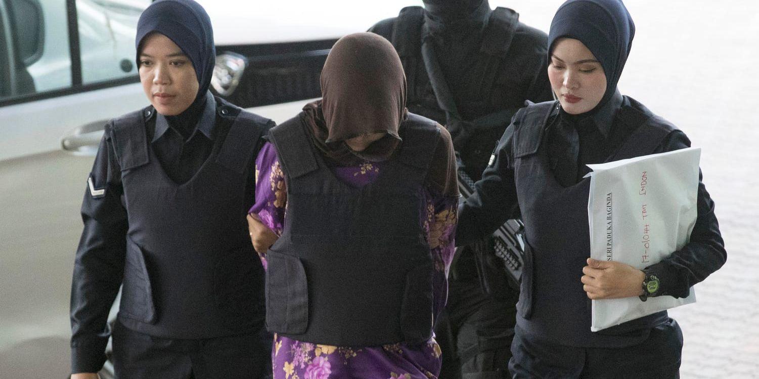 Vietnamesiska Doan Thi Huong, i mitten, förs in i rättssalen i Malaysia i december 2018. Nu återupptas rättegången mot henne. Arkivbild.