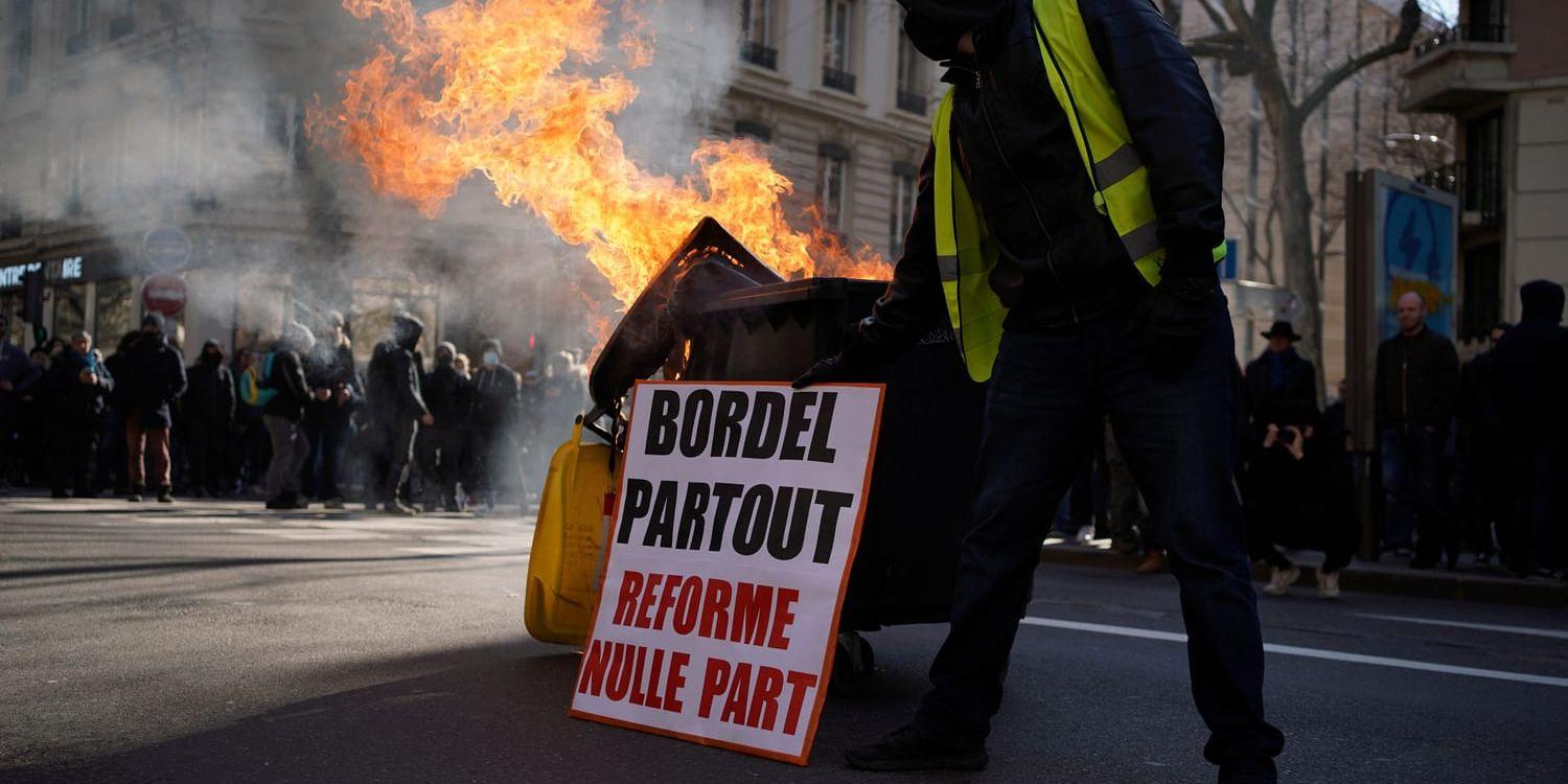 'Kaos överallt, reform ingenstans', står det på ett plakat invid en brinnande soptunna i Lyon i sydöstra Frankrike.