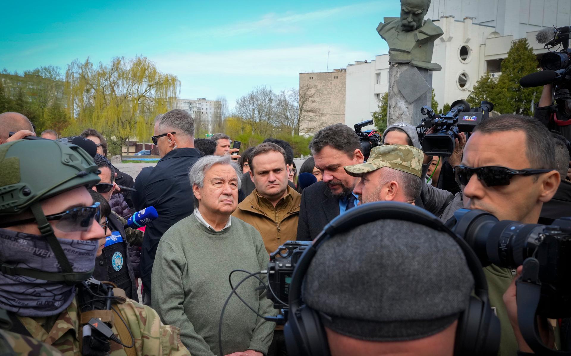 U.N. Secretary-General Antonio Guterres, center, looks at the houses destroyed by Russian shelling, a monument to Taras Shevchenko, a Ukrainian poet and a national symbol in the background, in Borodyanka on the outskirts of Kyiv, Ukraine, Thursday, April 28, 2022. (AP Photo/Efrem Lukatsky)  XEL113